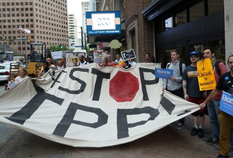Protestors call for the rejection of the Trans-Pacific Partnership trade deal under negotiation in Atlanta, Georgia on October 1, 2015