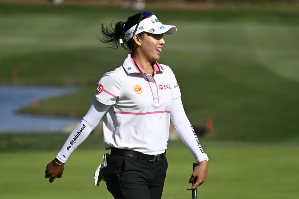 Atthaya Thitikul, of Thailand, sticks out her tongue as she walks to the 18th green during the final round of the JTBC LPGA golf tournament, Sunday, March 27, 2022, in Carlsbad, Calif. (AP Photo/Denis Poroy)