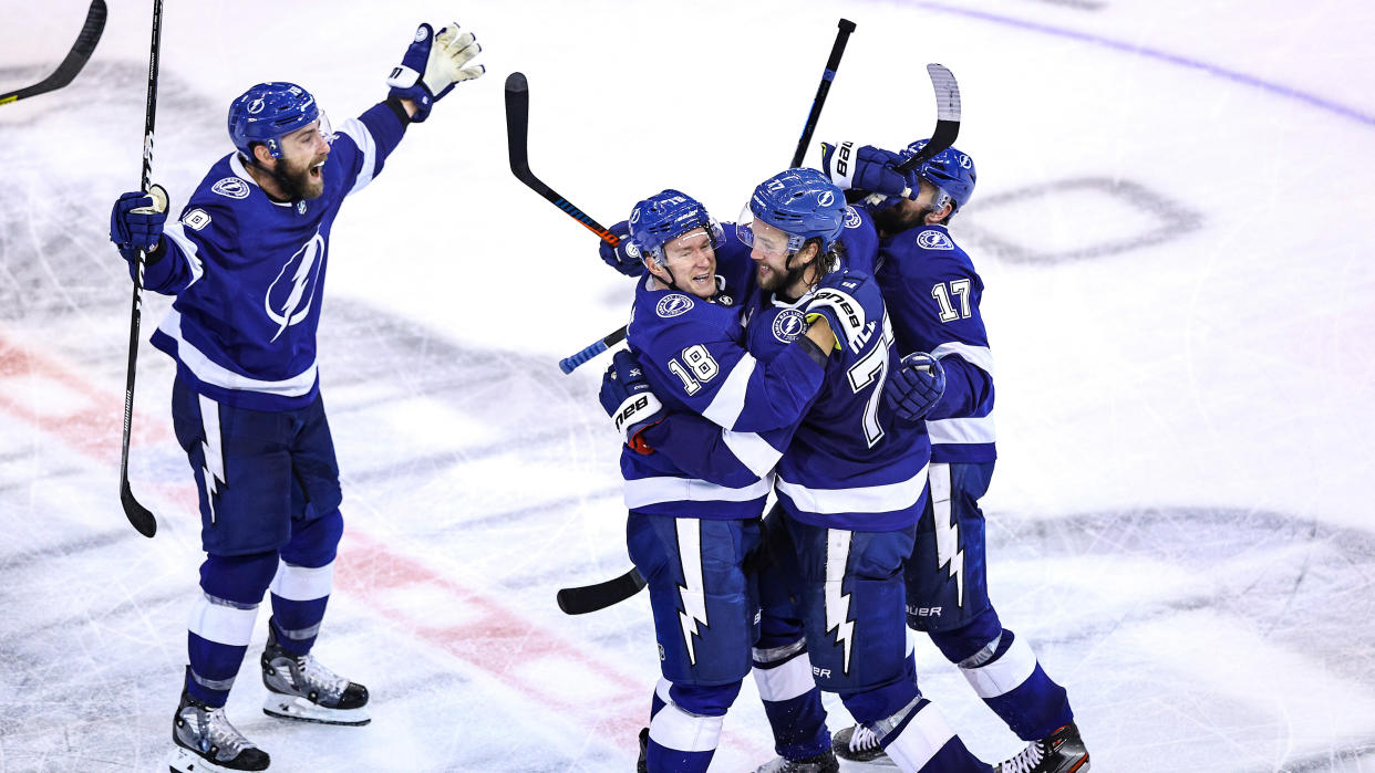 TORONTO, ONTARIO - AUGUST 31:  Victor Hedman #77 of the Tampa Bay Lightning is congratulated by his teammates, Ondrej Palat, Alex Killorn, and Barclay Goodrow after scoring the game-winning goal during the second overtime period to give his team the 3-2 victory against the Boston Bruins in Game Five of the Eastern Conference Second Round during the 2020 NHL Stanley Cup Playoffs at Scotiabank Arena on August 31, 2020 in Toronto, Ontario. (Photo by Elsa/Getty Images)