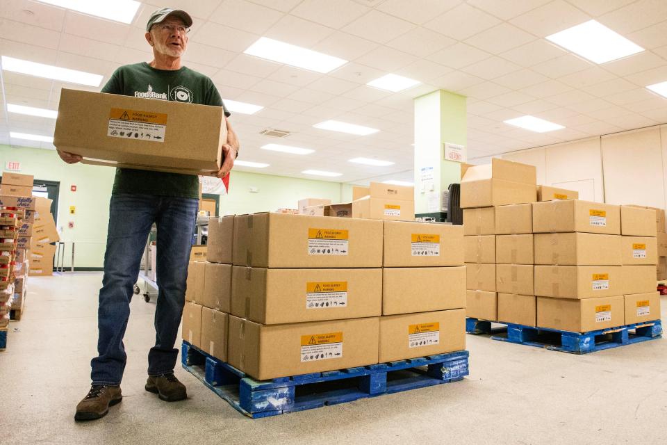 Phil Williamson, a volunteer for 12 years at the Food Bank of Delaware, organizes food boxes in the volunteer room at the Food Bank in Milford, Thursday, Nov. 9, 2023.