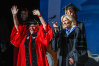 First lady Jill Biden, right, and Los Angeles City College President Mary Gallagher wave to graduates during the school's commencement ceremony in Los Angeles, Tuesday, June 7, 2022. (AP Photo/Ringo H.W. Chiu)