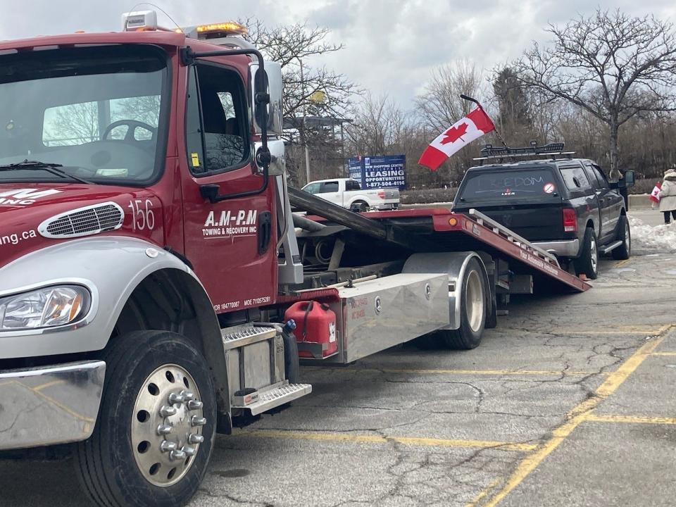 Cars were being towed Sunday, Feb. 13, 2022, as part of the Ambassador Bridge protests.