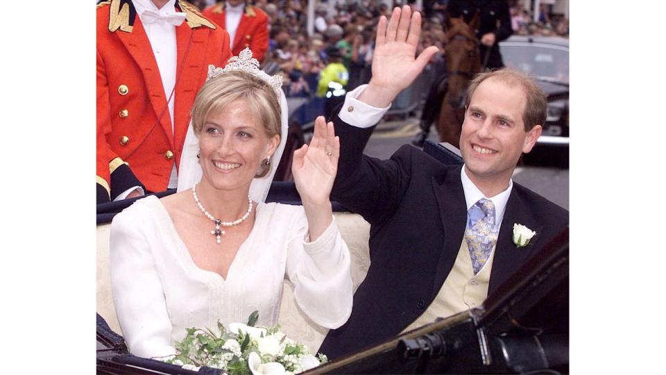 Duchess Sophie and Prince Edward waving from a carriage on their wedding day