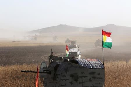 Kurdish Peshmerga forces ride on military vehicles on the southeast of Mosul , Iraq, August 14, 2016. REUTERS/Azad Lashkari