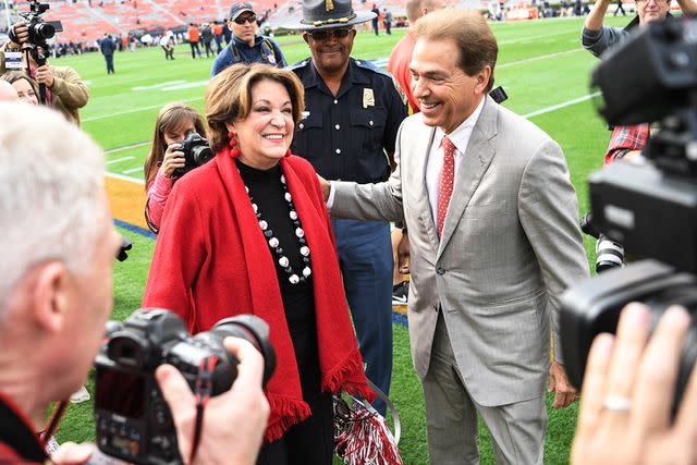 <p>Chip Dillard/Icon Sportswire/Getty</p> Nick Saban greets wife Terry Saban on the sidelines.