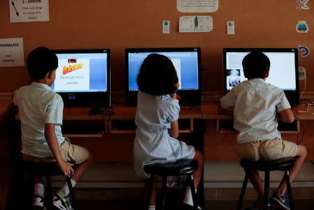 Students use computers in the technology lab at the Headstart private school in Islamabad, Pakistan, October 9, 2017. REUTERS/Caren Firouz