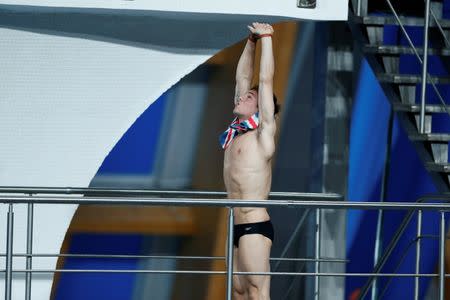 Britain's Thomas Daley stretches before jumping during the men's 10m platform semi-final at the Aquatics World Championships in Kazan, Russia August 1, 2015. REUTERS/Stefan Wermuth