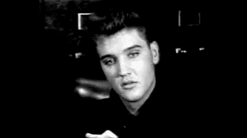 GIF of Elvis with a '50s hairdo smiling in a swivel chair