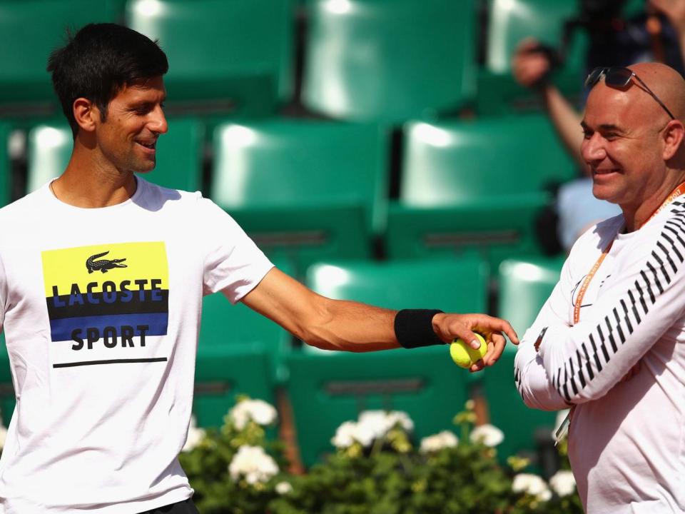 Andre Agassi and Novak Djokovic together in training (Getty)