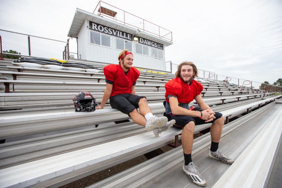 Rossville's senior quarterback Torrey Horak (right) and senior running back Corey Cantron sit on the stands they played behind growing up as kids attending Rossville football games.