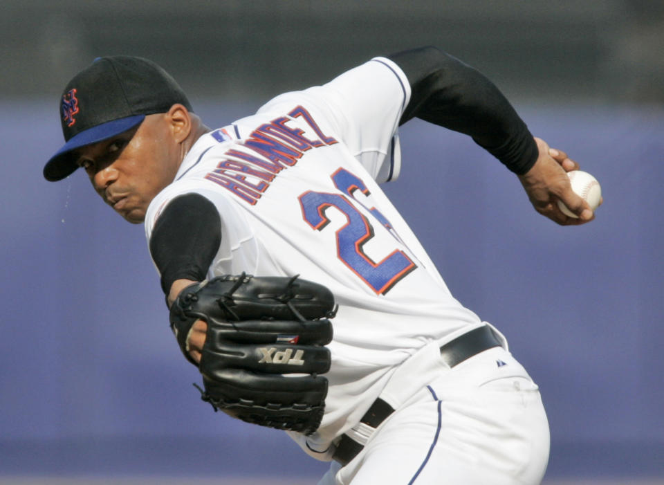FILE - In this Saturday, Aug. 25, 2007 file photo, New York Mets pitcher Orlando Hernandez (26) delivers a pitch during the second inning of baseball action against the Los Angeles Dodgers at Shea Stadium in New York. Cubans can sign under rules similar to what players from Japan, South Korea and Taiwan face, according to a new agreement between Major League Baseball, its players’ association and the Cuban Baseball Federation. Players from Cuba would be allowed to sign big league contracts without defecting. (AP Photo/Frank Franklin II, File)