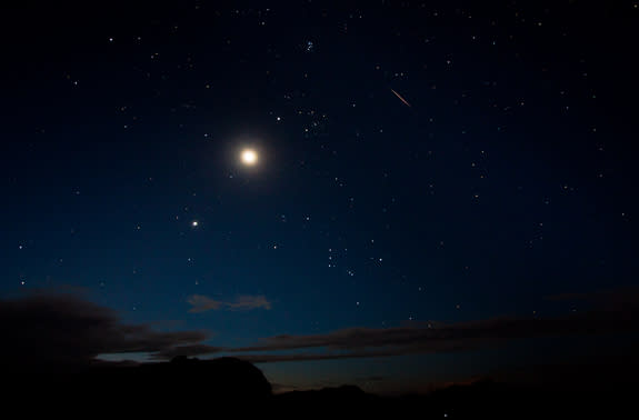 The moon and Venus shine bright alongside a Perseid meteor (upper right) on Aug. 12 in this view by photographer Tyler Leavitt in Las Vegas, Nevada, during the peak of the 2012 Perseid meteor shower on Aug. 12.