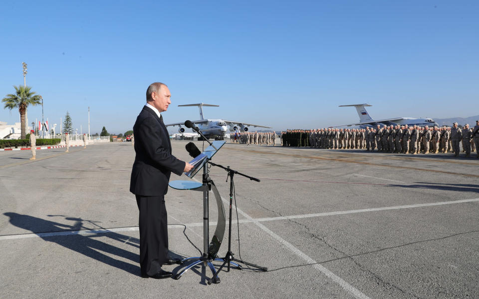 FILE - Russian President Vladimir Putin addresses to the troops at the Hemeimeem air base in Syria, Dec. 11, 2017. Political observers say Russia’s brazen Syria intervention emboldened Putin, giving him a renewed Middle East foothold and helped pave the way for his current attack on Ukraine. (Mikhail Klimentyev, Sputnik, Kremlin Pool Photo via AP, File)