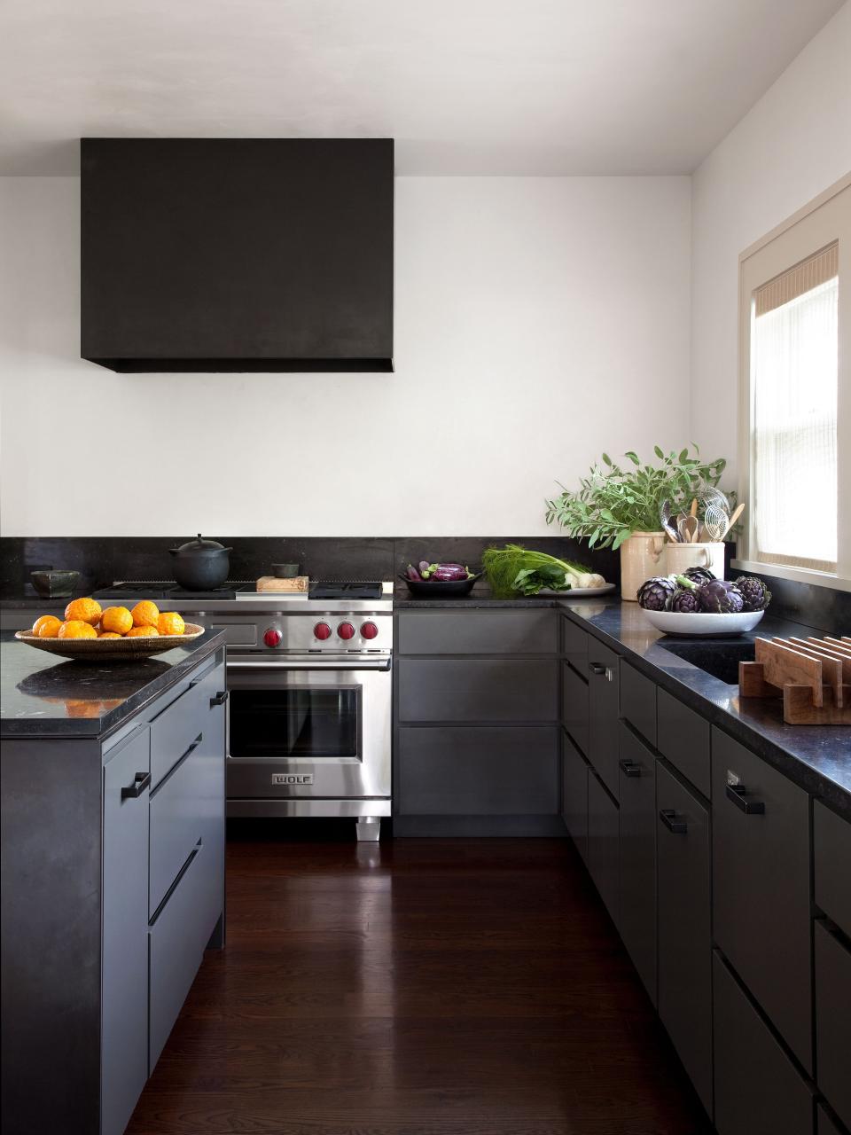 In keeping with Tedhams’s reliance on a limited palette, the kitchen cabinets are painted the same color as the exterior of the house. Countertops are Belgian bluestone. Range by Wolf; dishwasher by Fisher & Paykel.