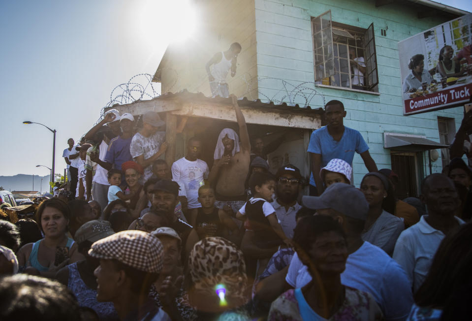 Community members call for the death penalty outside the house of 8-year-old Tazne Van Wyk, who was raped and murdered, in Cape Town, South Africa, Feb. 25, 2020. Tazne's parents blame the correctional system for paroling the man charged with her murder despite a history of violent offenses against children. (AP Photo/Bram Janssen)