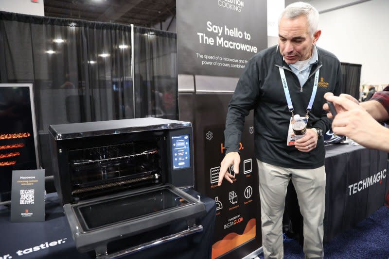 An exhibitor points out the features of The Macrowave cooking appliance by Revolution Cooking, on display during the 2024 International CES at the Mandalay Bay Convention Center in Las Vegas, Photo by James Atoa/UPI