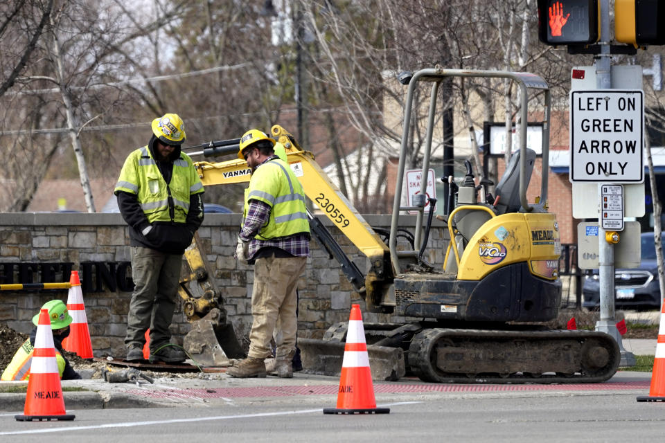 Construction workers work in Wheeling, Ill., Wednesday, March 31, 2021. President Joe Biden will unveil his $2 trillion infrastructure plan and the plan aims to revitalize U.S. transportation infrastructure, water systems, broadband and manufacturing, among other goals. (AP Photo/Nam Y. Huh)