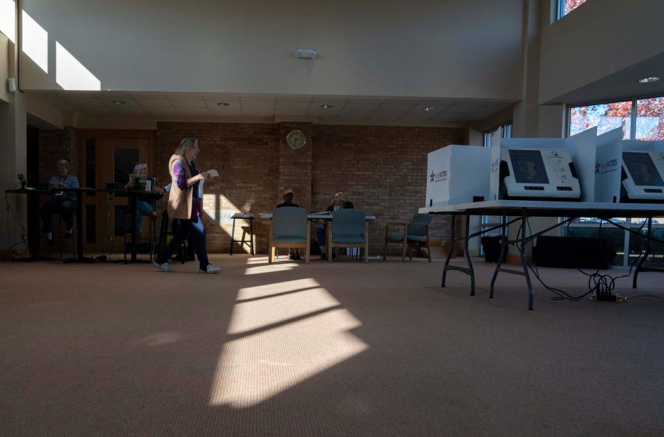 A voter walks to cast her ballot Tuesday, Nov. 8, 2022, at Chin Christian Church in Indianapolis.