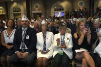 People listen as President Donald Trump speaks at the American Veterans (AMVETS) 75th National Convention in Louisville, Ky., Wednesday, Aug. 21, 2019. (AP Photo/Susan Walsh)
