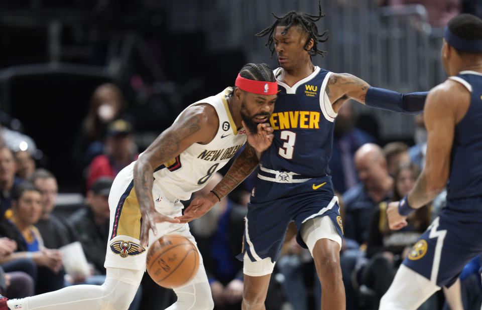 New Orleans Pelicans forward Naji Marshall, left, runs into Denver Nuggets guard Bones Hyland in the first half of an NBA basketball game Tuesday, Jan. 31, 2023, in Denver. (AP Photo/David Zalubowski)