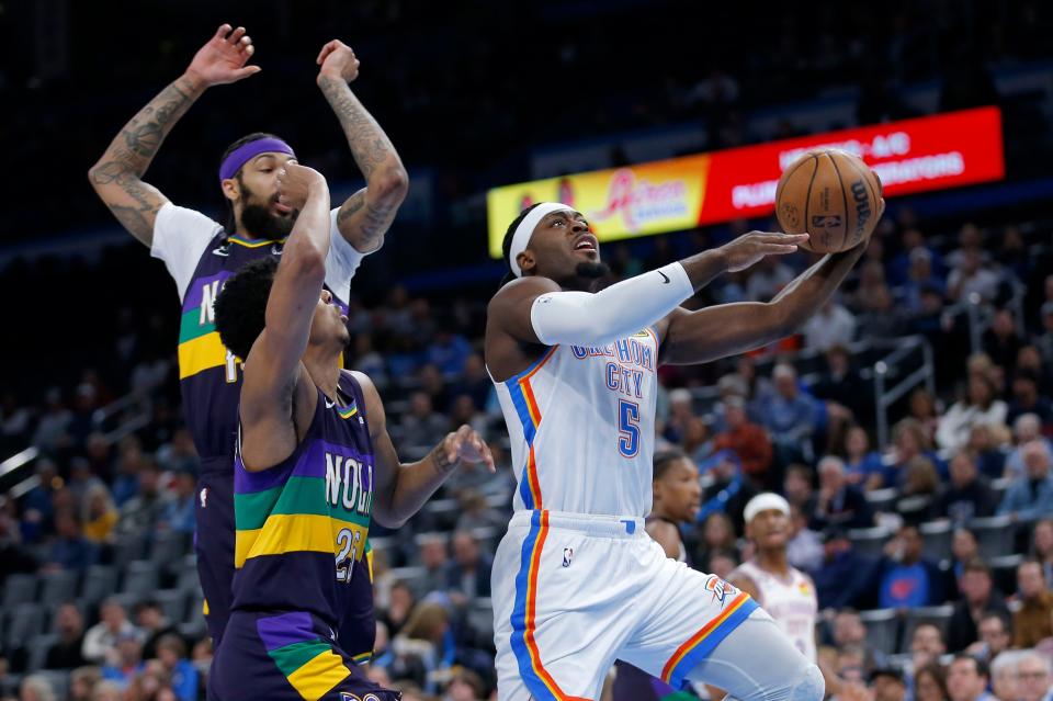 Oklahoma City's Luguentz Dort (5) goes up for a basket as New Orleans' Trey Murphy III (25) defend in the first half during the NBA basketball game between the Oklahoma City Thunder and the New Orleans Pelicans at the Paycom Center in Oklahoma City, Monday, Feb.13, 2023. 