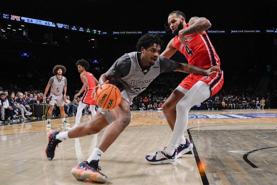 St. Bonaventure forward Chad Venning, front left, drives to the basket against Auburn forward Johni Broome (4) during the second half of an NCAA college basketball game in the final of the Legends Classic tournament in New York, Friday, Nov. 17, 2023. (AP Photo/Peter K. Afriyie)