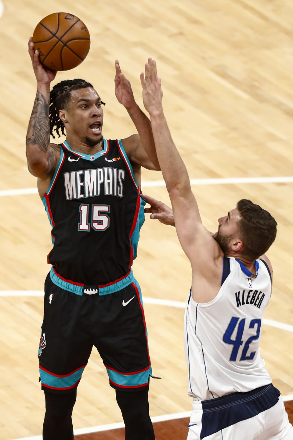 Memphis Grizzlies forward Brandon Clarke (15) shoots over Dallas Mavericks forward Maxi Kleber (42) during the first half of an NBA basketball game Tuesday, May 11, 2021, in Memphis, Tenn. (AP Photo/Wade Payne)