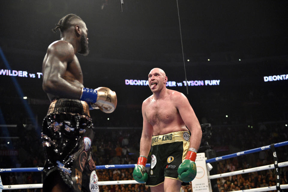 Deontay Wilder prepares for Tyson Fury as he sticks out his tongue to mock him in the ring.