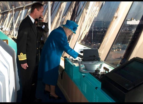 Queen Elizabeth (C), sounds the ship's sirens.          <em>ARTHUR EDWARDS/AFP/Getty Images</em>