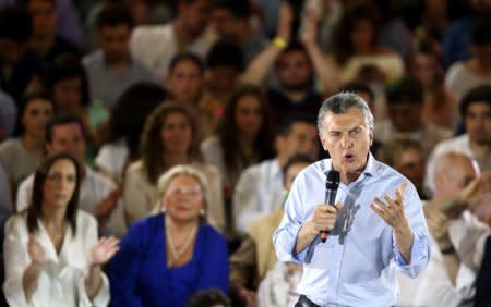 Argentina's President Mauricio Macri speaks in front of Buenos Aires province governor Maria Eugenia Vidal (L, back) and Lower House candidate Elisa Carrio (C, back) during a campaign rally ahead of mid-term elections in Buenos Aires, Argentina October 17, 2017. REUTERS/Marcos Brindicci