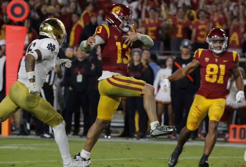 USC quarterback Caleb Williams runs into the end zone while carrying the ball against Notre Dame in 2022