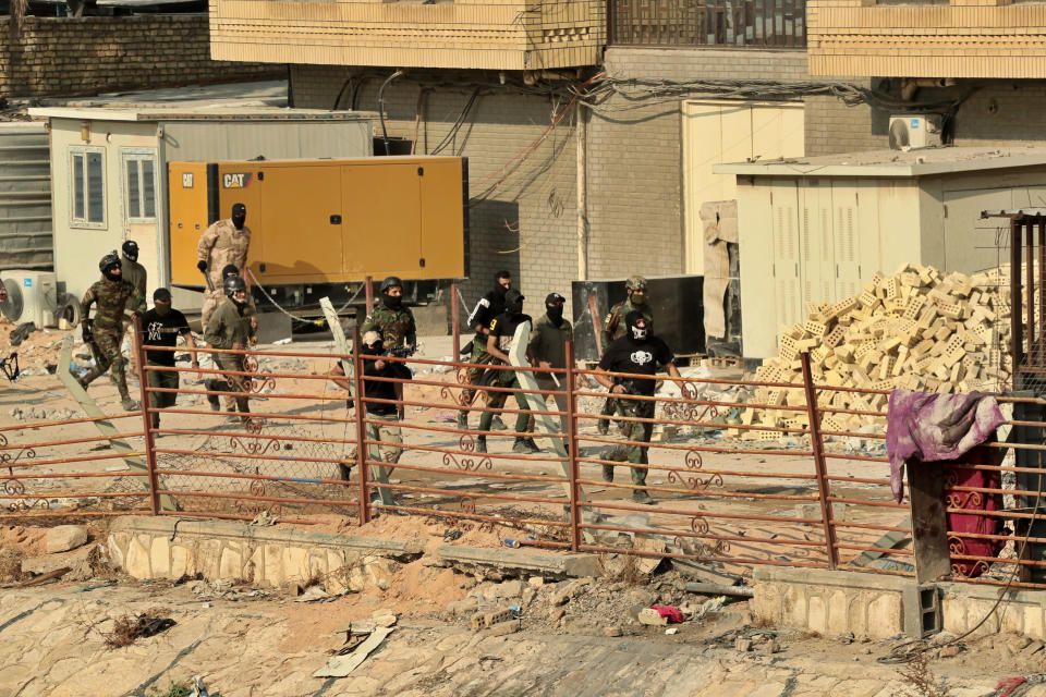 Security forces try to disperse anti-government protesters during clashes on Rasheed Street in Baghdad, Iraq, Tuesday, Nov. 26, 2019. (AP Photo/Hadi Mizban)