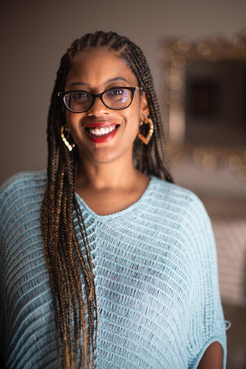 Realtor Stefphanie Galloway takes care of her braids at her home in Columbus.