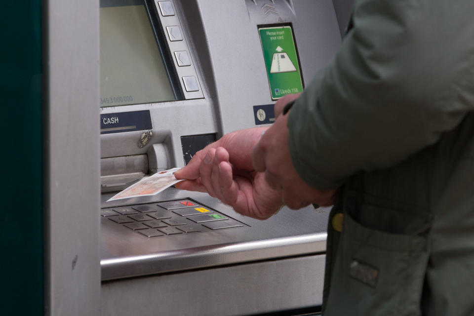 EMBARGOED TO 0001 MONDAY JULY 22 File photo dated 14/09/17 of a man withdrawing money from an ATM. The volume of cash withdrawals from ATMs declined year-on-year across the UK's nations and regions in early 2019, according to cash machine network Link.