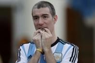 A fan of Argentina reacts while watching a broadcast of the 2014 World Cup final against Germany at the Argentine Embassy in Brasilia, July 13, 2014. REUTERS/Ueslei Marcelino (BRAZIL - Tags: SOCCER SPORT WORLD CUP)