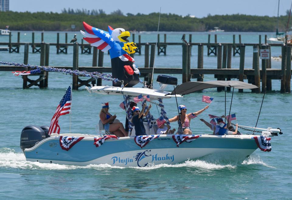 People on the Playin' Hooky boat celebrate Independence Day during Fort Pierce Yacht Club's 13th annual Patriotic Boat Parade. Boats, decorated in red, white and blue, cruised on the Indian River Lagoon, Tuesday, July 4, 2023. It began at the turning basin just north of the South Causeway Bridge. It was one of many Independence Day events on the Treasure Coast, and one of several in St. Lucie County, including  Stars Over St. Lucie in Fort Pierce, Freedomfest in Port St. Lucie, Tradition’s 4th of July Celebration, and fireworks with the St. Lucie Mets.