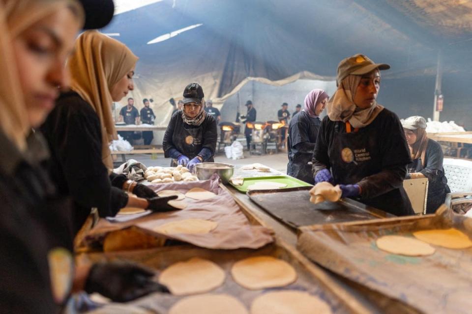 World Central Kitchen team prepare food for displaced Palestinians after resuming work in Gaza in this handout picture released on 30 April (Reuters)