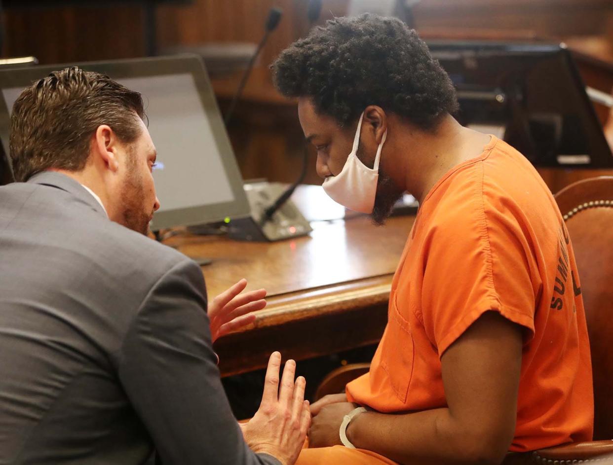 Defense attorney Jeff Laybourne, left, talks with Willie James before James' sentencing Friday in Summit County Court of Common Pleas.