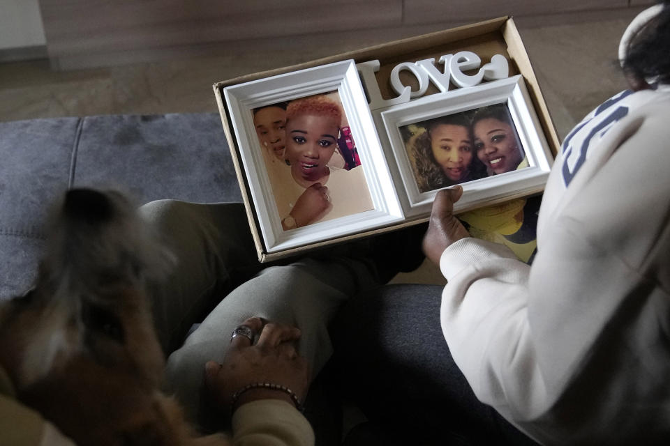 Ella Anthony and her partner Doris Ezuruike Chinons show photos of themselves during an interview in their house in Passo Corese, near Rome, Monday, March 11, 2024. Knowing that she faced a possible prison term since Nigeria criminalizes same-sex relationships, Anthony fled with her partner to Libya in 2014 and then Italy, where they both won asylum. Their claim? That they had a well-founded fear of anti-LGBTQ+ persecution back home. (AP Photo/Alessandra Tarantino)