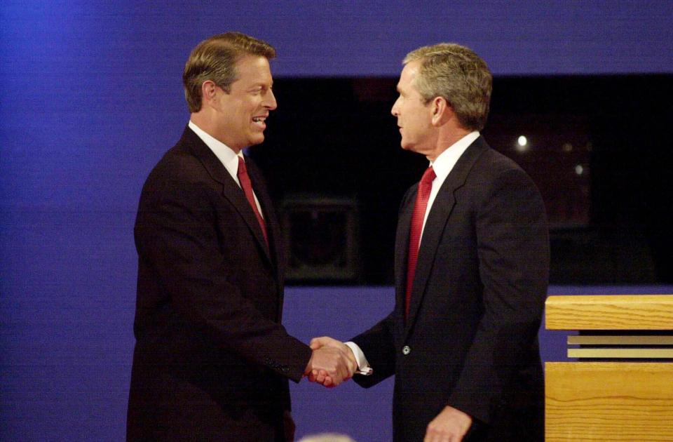 Republican presidential candidate George W. Bush and Democratic presidential candidate Al Gore shake hands at the end of their first debate  October 3, 2000, at the University of Massachusetts-Boston. 