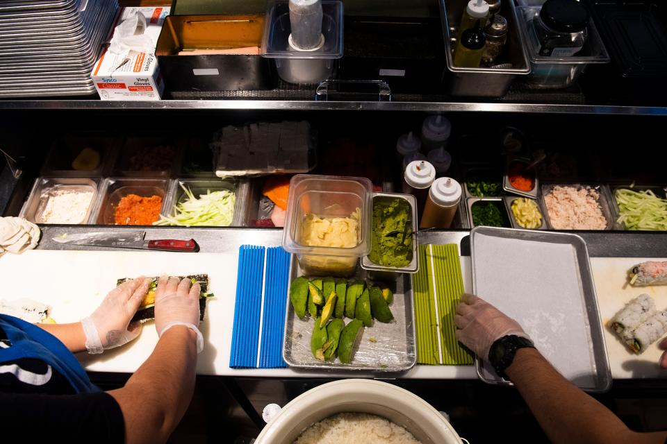 Jlendi Maldanado and Osim Alvarado prepare sushi at Horu Sushi at Assembly Food Hall in Nashville.