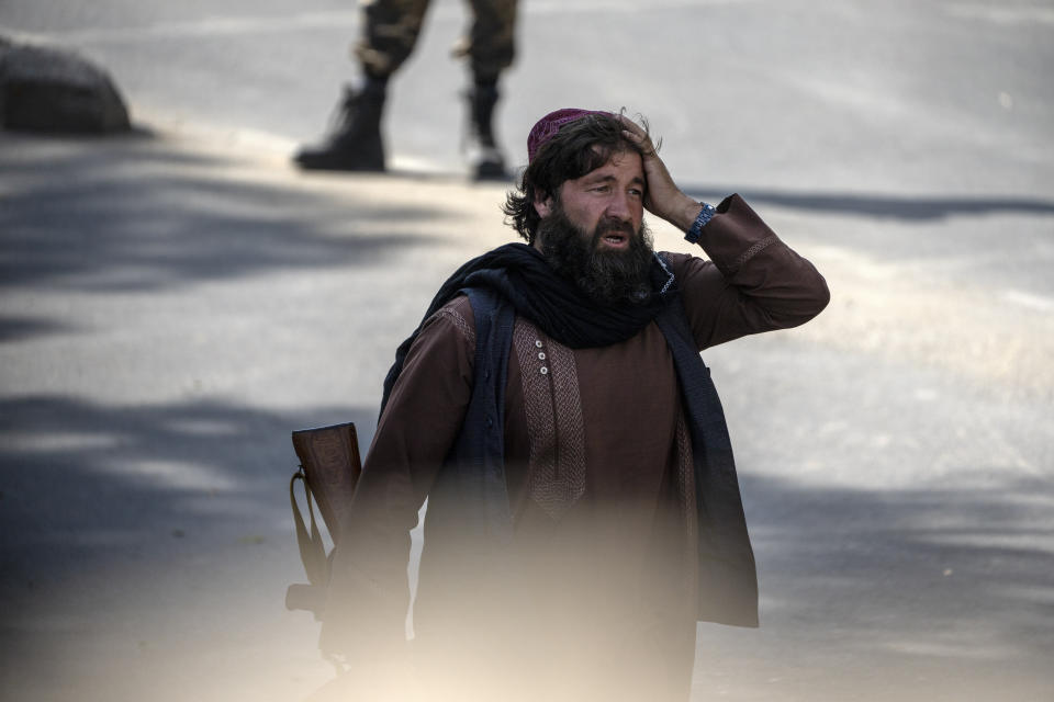 A shocked Taliban fighter stands guard at the explosion site, near a mosque, in Kabul, Afghanistan, Friday, Sept. 23, 2022. An explosion went off near a mosque in Afghanistan's capita on Friday, with police confirming casualties. (AP Photo/Ebrahim Noroozi)