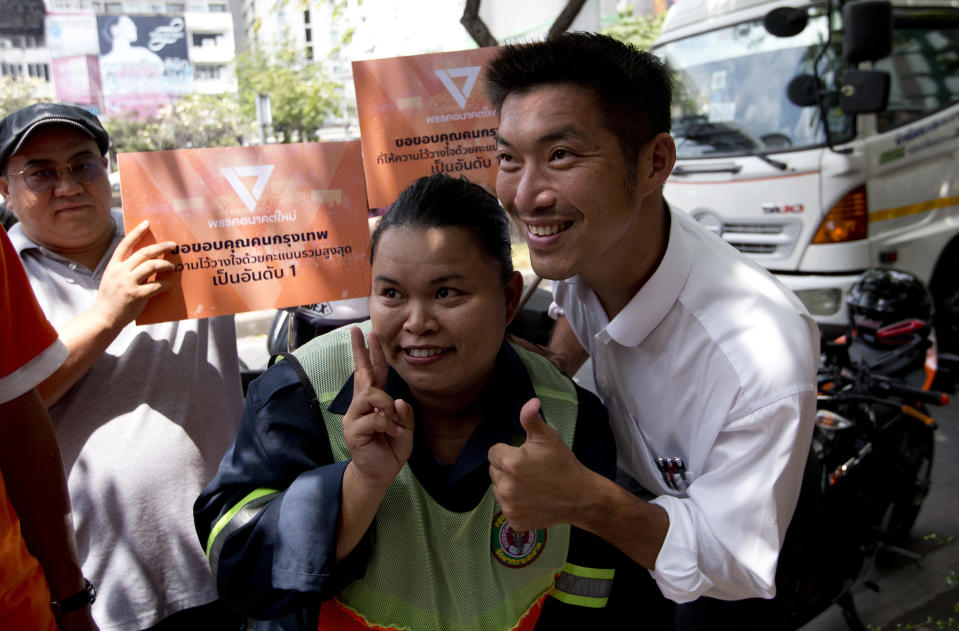 Thailand's Future Forward Party leader Thanathorn Juangroongruangkit, right takes a picture with a supporter before on vehicle to thank people who came out to vote Bangkok, Thailand, Wednesday, April 3, 2019. Thailand's ruling junta has filed a complaint accusing Thanathorn of sedition and aiding criminals. The Future Forward Party ran a strong third in the elections last month that were also contested by a pro-military party. (AP Photo/Sakchai Lalit)