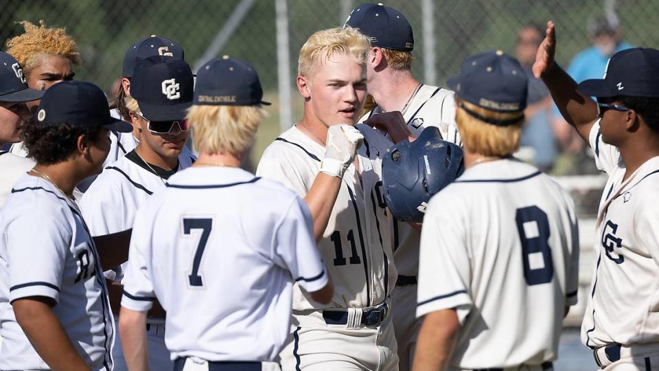 Central Catholic’s TP Wentworth is greeted by teammates at home plate after hitting a two-run homer during the Division III Sac-Joaquin Section playoff game with Christian Brothers at Central Catholic High School in Modesto, Calif., Wednesday, May 17, 2023. The Raiders won the game 8-1.