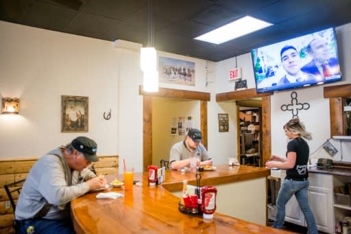 Diners eat at the counter at Shooters Grill in Rifle, Colorado on April 24, 2018