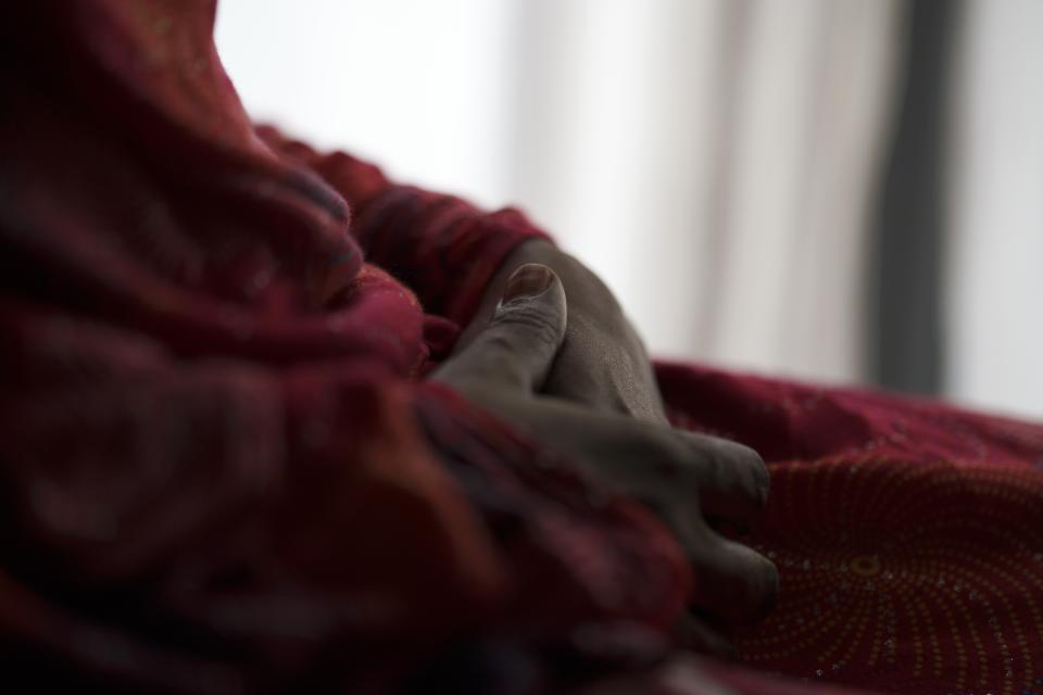 A 40-year-old poses for a photo after an interview in Saint Louis, Senegal, Saturday, Jan. 21, 2023. She said she had to resort to prostitution last year after her husband left the city and cut contact. (AP Photo/Leo Correa)