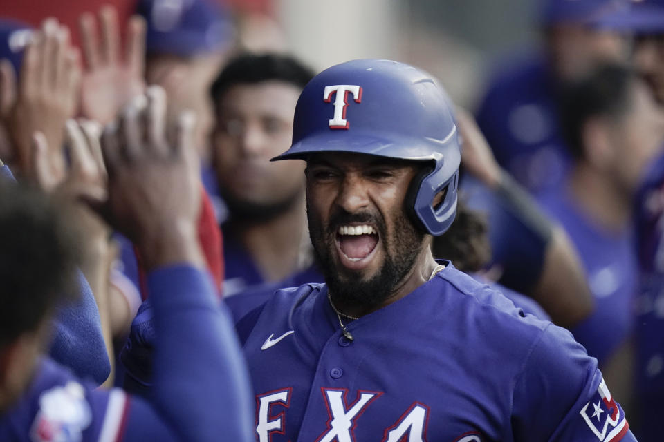 Texas Rangers' Marcus Semien is congratulated for his three-run home run during the fourth inning of a baseball game against the Los Angeles Angels on Saturday, July 30, 2022, in Anaheim, Calif. (AP Photo/Jae C. Hong)