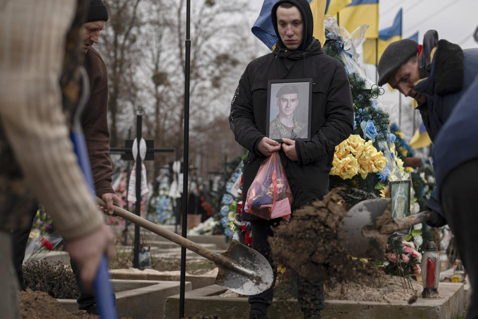 Cemetery workers bury the coffin of Ukrainian soldier Danylo Lysenko, 22, during his funeral in Boyarka, near Kyiv, Ukraine, Saturday, March 18, 2023. Danylo Lysenko died as a result of artillery shelling by Russian troops in the city of Kreminna, Luhansk region. He was a sapper in the air assault forces. (AP Photo /Andrew Kravchenko)