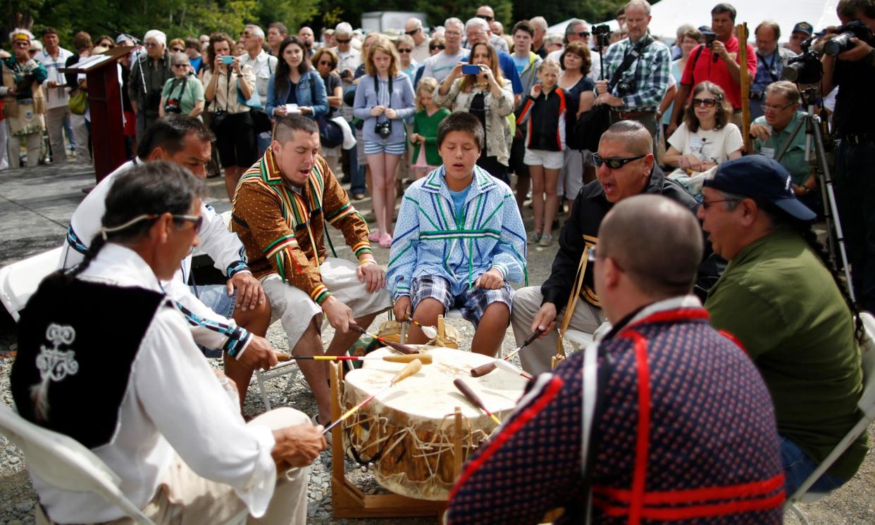 <span>Penobscot Nation members drum on the Penobscot River in Eddington, Maine, on 22 July 2013. </span><span>Photograph: Boston Globe/Getty Images</span>