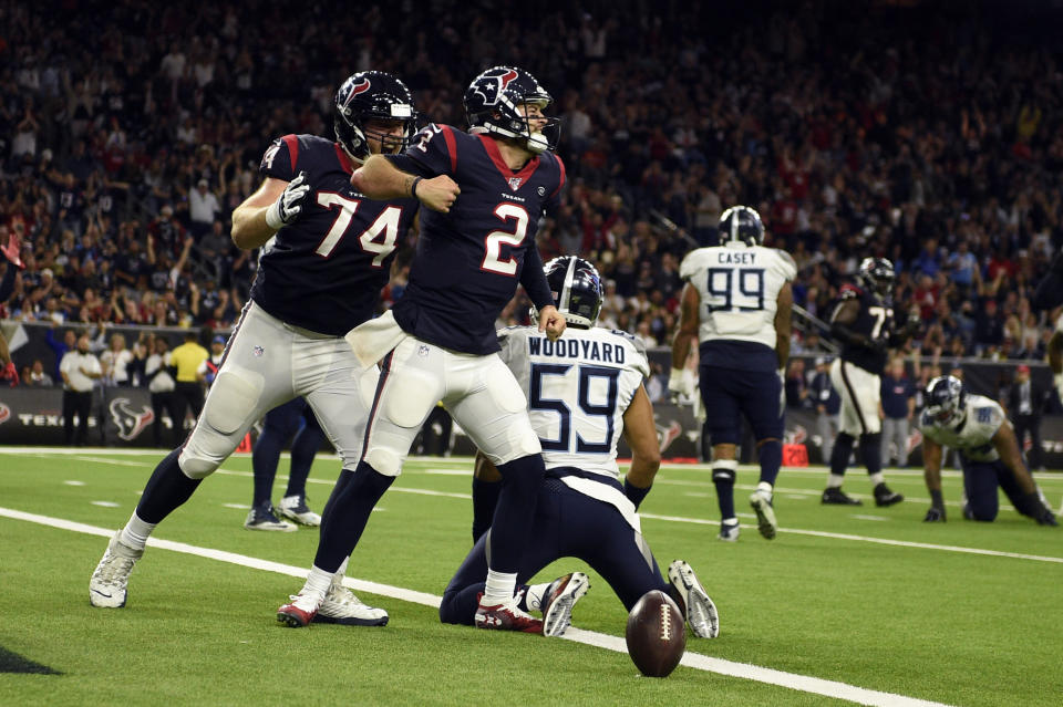 Houston Texans quarterback AJ McCarron (2) celebrates after scoring a touchdown as offensive guard Max Scharping (74) joins him while Tennessee Titans inside linebacker Wesley Woodyard (59) kneels at the goal line during the second half of an NFL football game Sunday, Dec. 29, 2019, in Houston. (AP Photo/Eric Christian Smith)